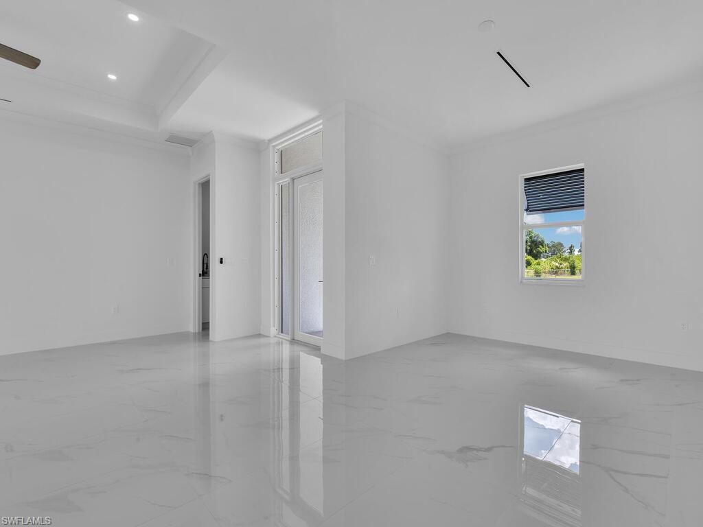 6108 Stratton Road Fort Myers, FL 33905 - Photo 8 of 27 Empty room featuring marble finish floors, ornamental molding, and recessed lighting