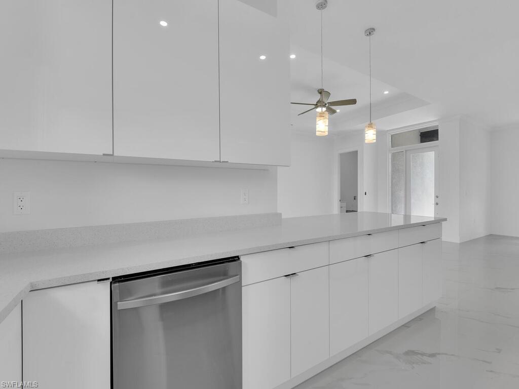 6108 Stratton Road Fort Myers, FL 33905 - Photo 10 of 27 Kitchen with modern cabinets, dishwasher, white cabinetry, light marble finish floors, and recessed lighting