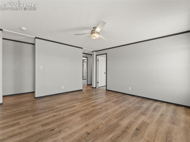 22843 Handle Road Calhan, CO 80808 - Photo 18 of 47 Unfurnished bedroom featuring light wood-style flooring, crown molding, and a ceiling fan