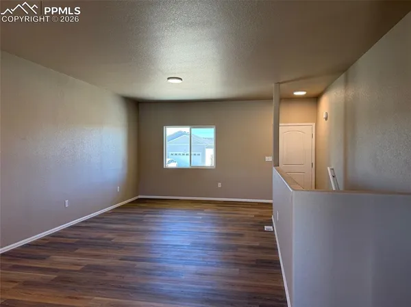 a kitchen with a sink a stove and wooden cabinets