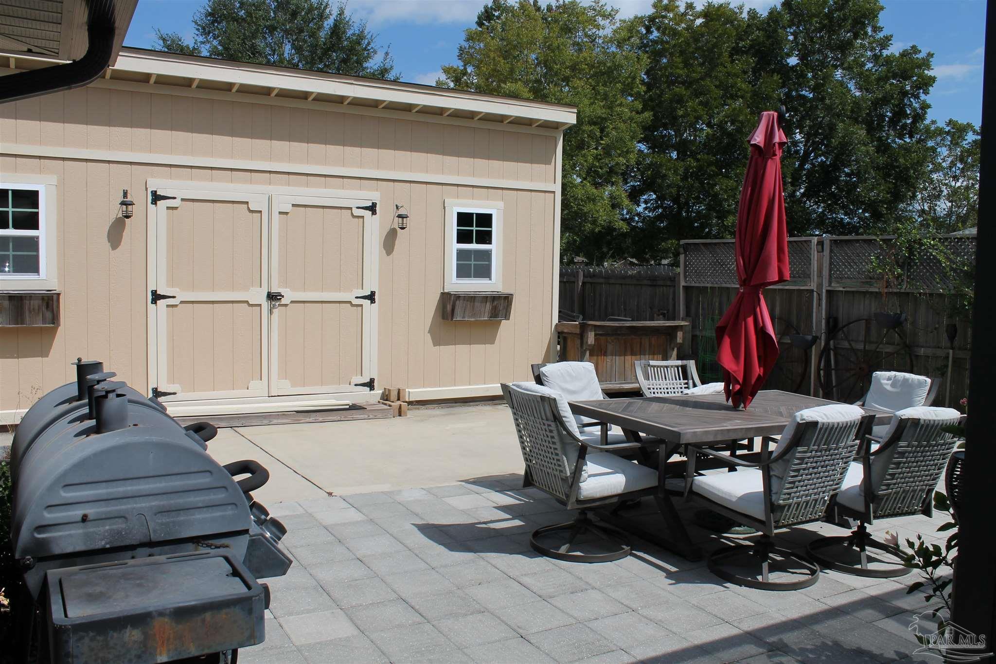 5468 Madelines Way Pace, FL 32571 - Photo 13 of 45 a view of a dinning table and chairs in patio of the house