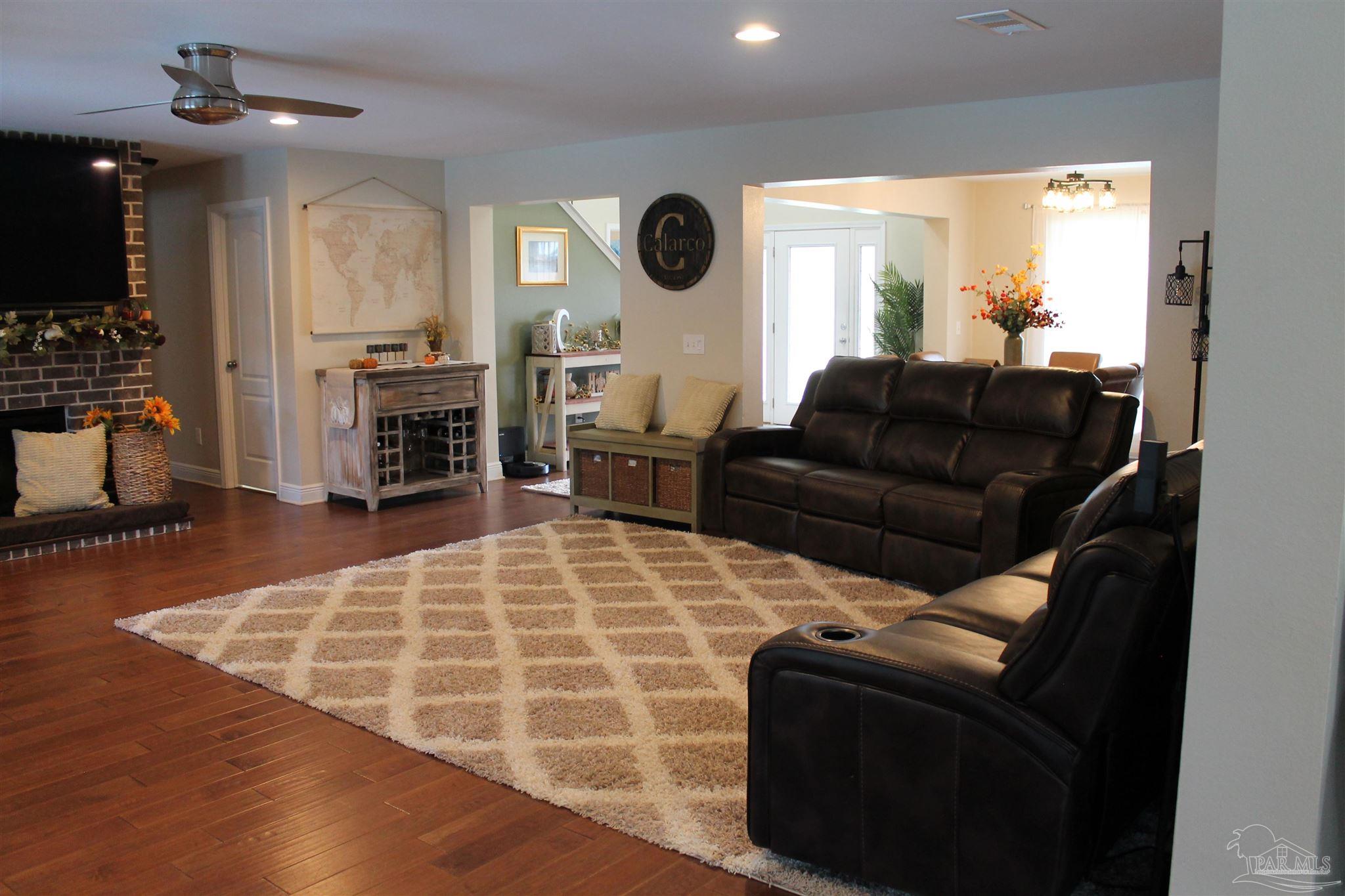 5468 Madelines Way Pace, FL 32571 - Photo 17 of 45 a living room with furniture lamp and window