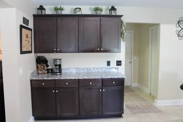 a kitchen with granite countertop cabinets and window