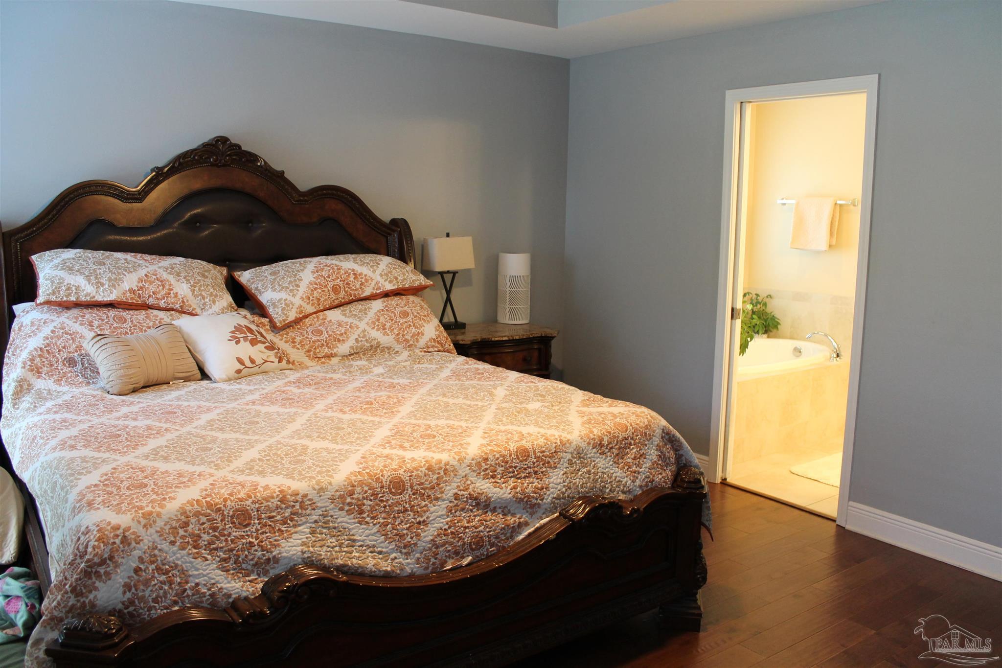 5468 Madelines Way Pace, FL 32571 - Photo 27 of 45 a bedroom with a bed and wooden floor