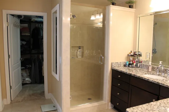 a bathroom with a shower sink and mirror