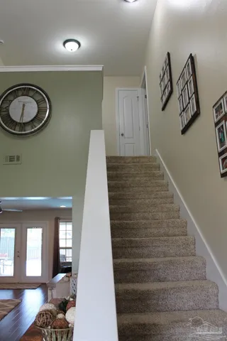a view of a hallway with entryway wooden floor and front door
