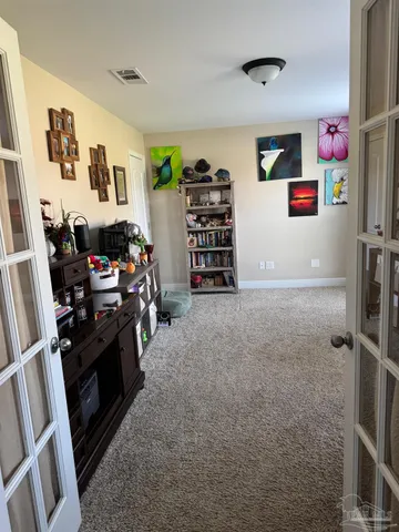 a view of a livingroom with furniture and a flat screen tv