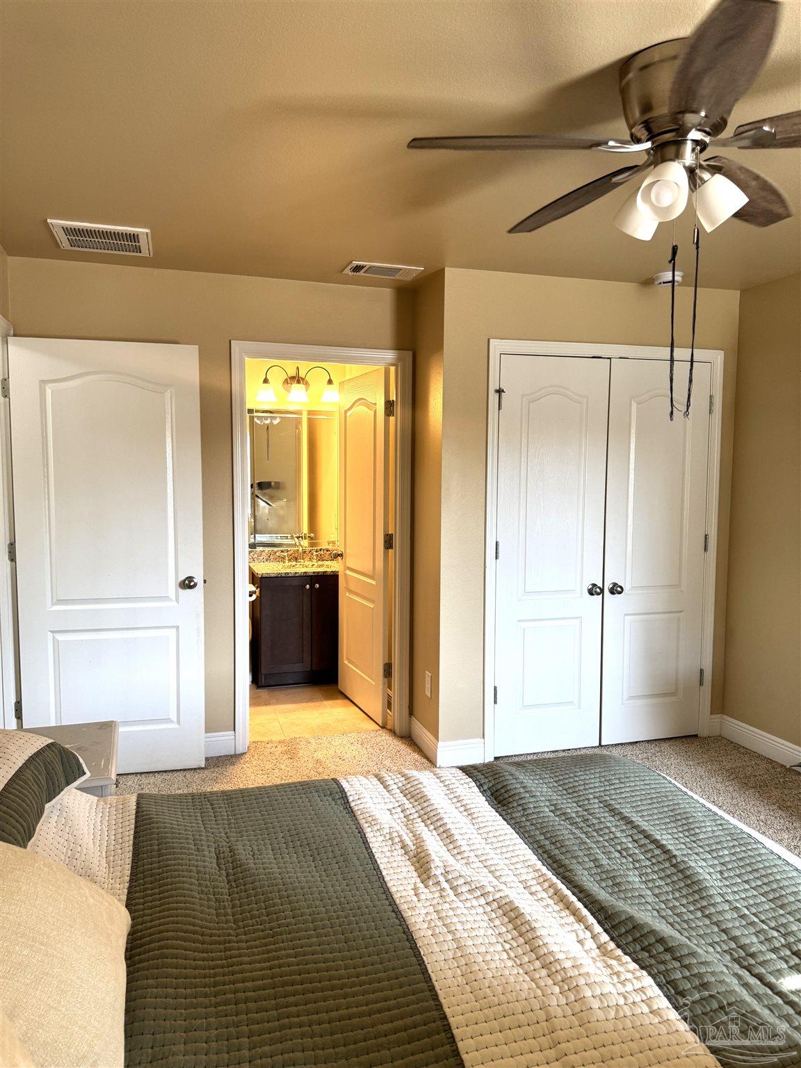 5468 Madelines Way Pace, FL 32571 - Photo 41 of 45 a bedroom with a bed and a chandelier