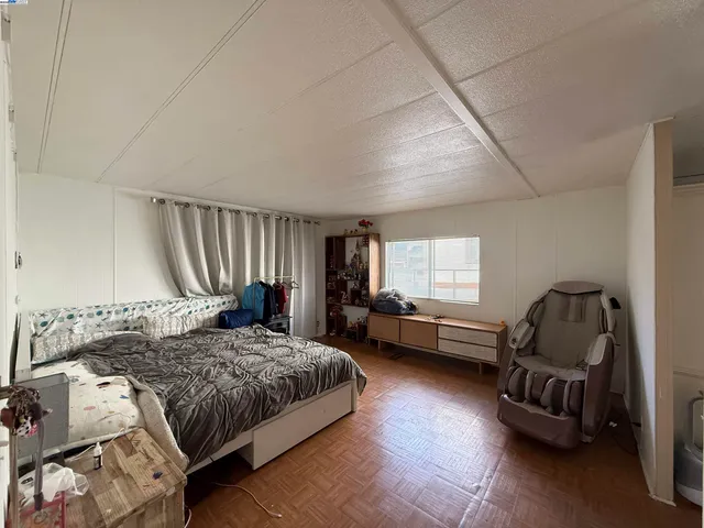 a bedroom with a bed chair and a window