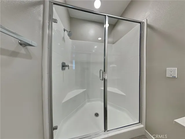 a bathroom with a glass shower door and a toilet