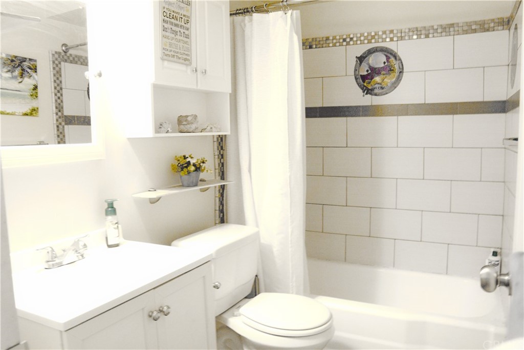 6038 KOA Drive Rialto, CA 92377 - Photo 11 of 18 a bathroom with a sink a toilet and shower