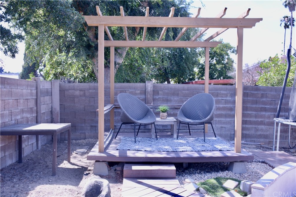 6038 KOA Drive Rialto, CA 92377 - Photo 16 of 18 a view of a patio with table and chairs potted plants