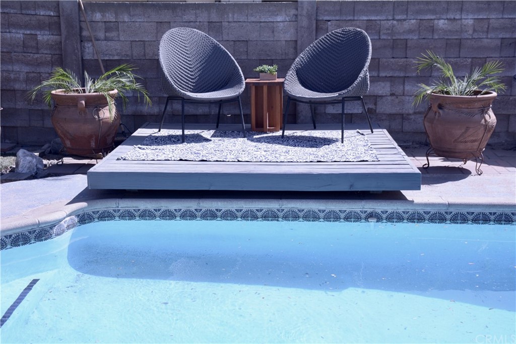 6038 KOA Drive Rialto, CA 92377 - Photo 17 of 18 a bathroom with a granite countertop sink and a mirror