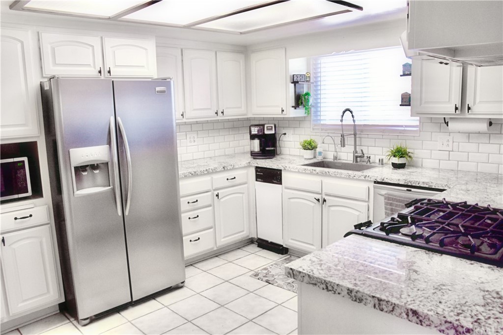 6038 KOA Drive Rialto, CA 92377 - Photo 2 of 18 a kitchen with stainless steel appliances a refrigerator sink and cabinets