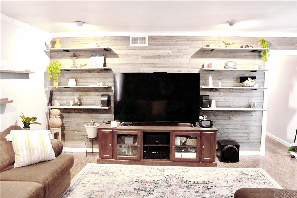 6038 KOA Drive Rialto, CA 92377 - Photo 5 of 18 a living room with a flat screen tv and a fireplace