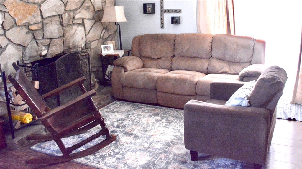 6038 KOA Drive Rialto, CA 92377 - Photo 6 of 18 a living room with furniture a couch and a fireplace