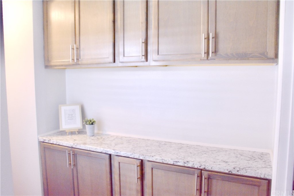 6038 KOA Drive Rialto, CA 92377 - Photo 8 of 18 a bathroom with a granite countertop sink and white cabinets