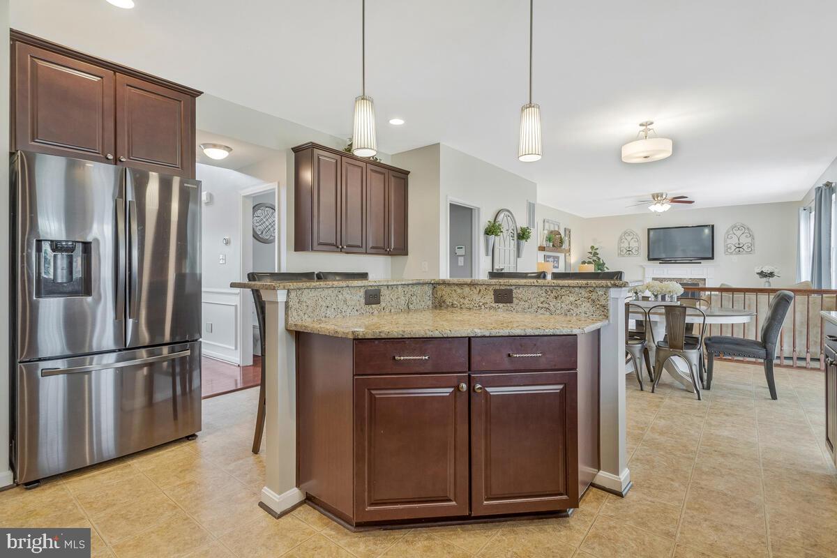 2066 Baythorne Road Prince Frederick, MD 20678 - Photo 13 of 54 a kitchen with kitchen island a center island a refrigerator a counter space and a sink