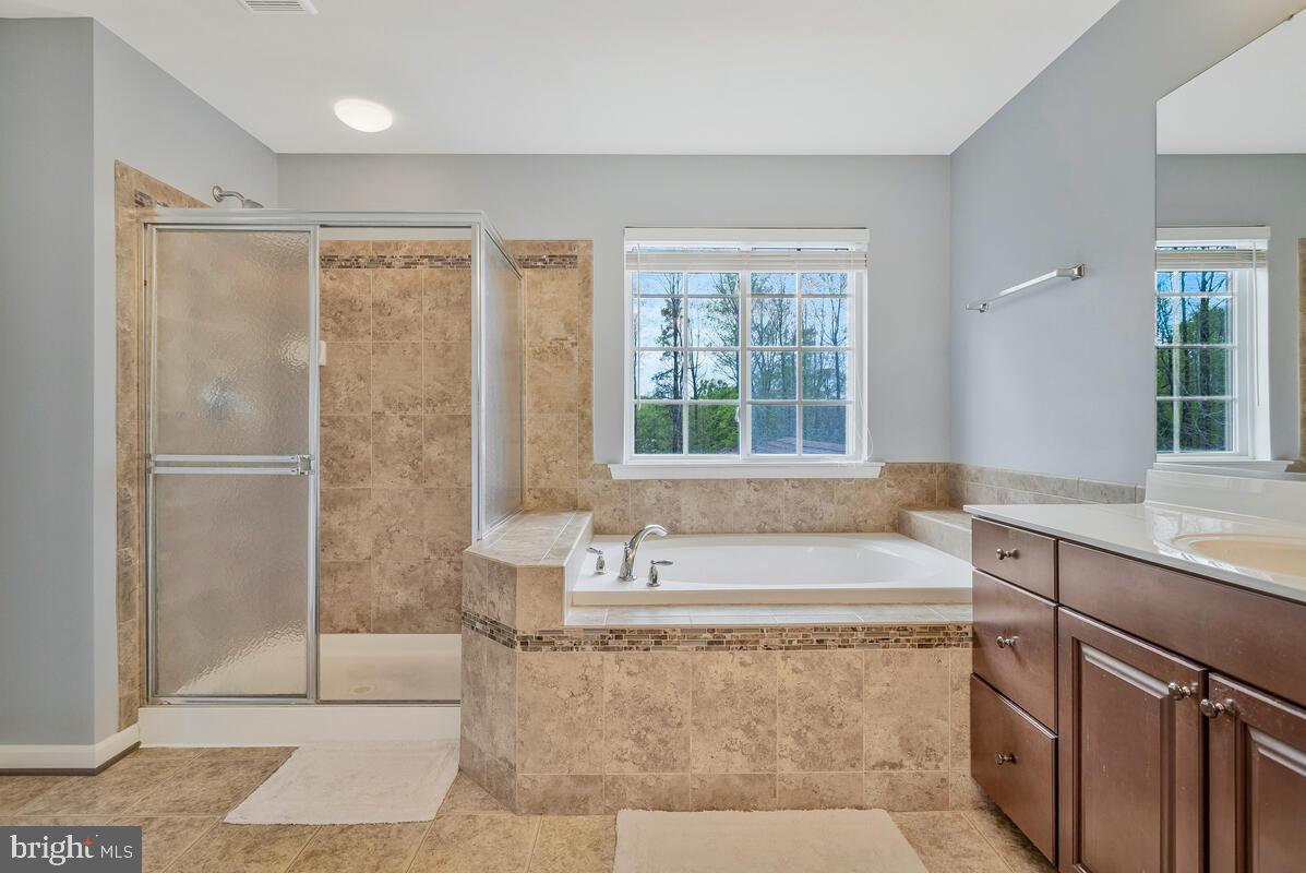 2066 Baythorne Road Prince Frederick, MD 20678 - Photo 28 of 54 a spacious bathroom with a tub sink and mirror