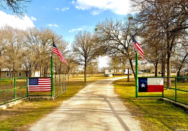 a kitchen with stainless steel appliances kitchen island granite countertop a table chairs and a refrigerator