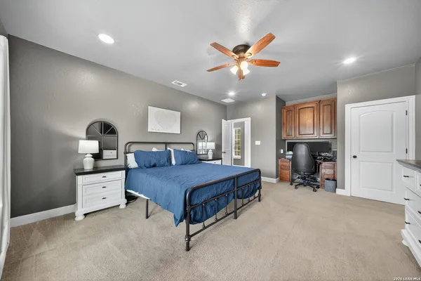 a bathroom with a granite countertop sink a toilet and shower