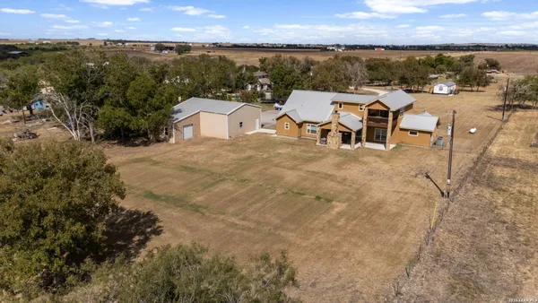 an aerial view of residential houses with outdoor space