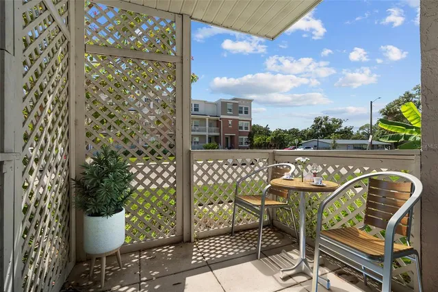 a balcony with table and chairs