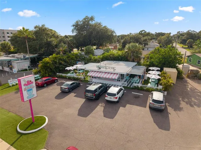 an aerial view of a house with a yard