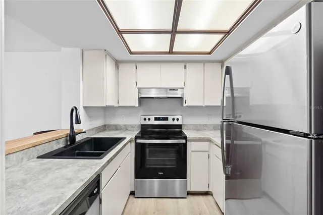 a kitchen with a stove and a refrigerator