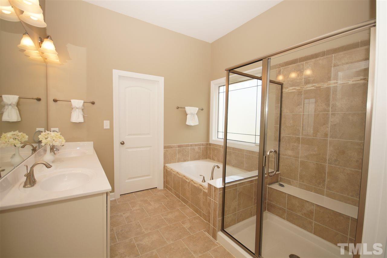 3015 Red Grape Drive Raleigh, NC 27607 - Photo 12 of 25 a bathroom with a tub and shower