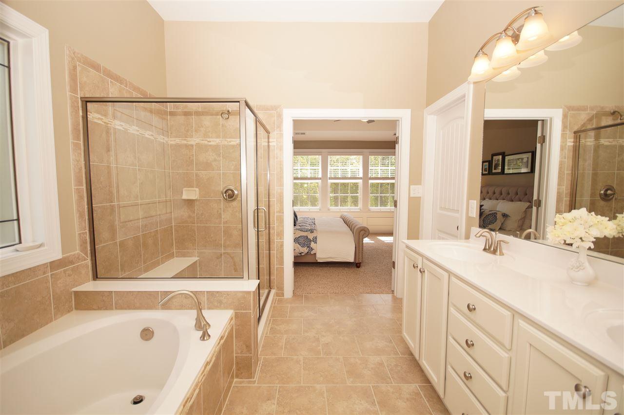 3015 Red Grape Drive Raleigh, NC 27607 - Photo 13 of 25 a spacious bathroom with a tub sink and a mirror