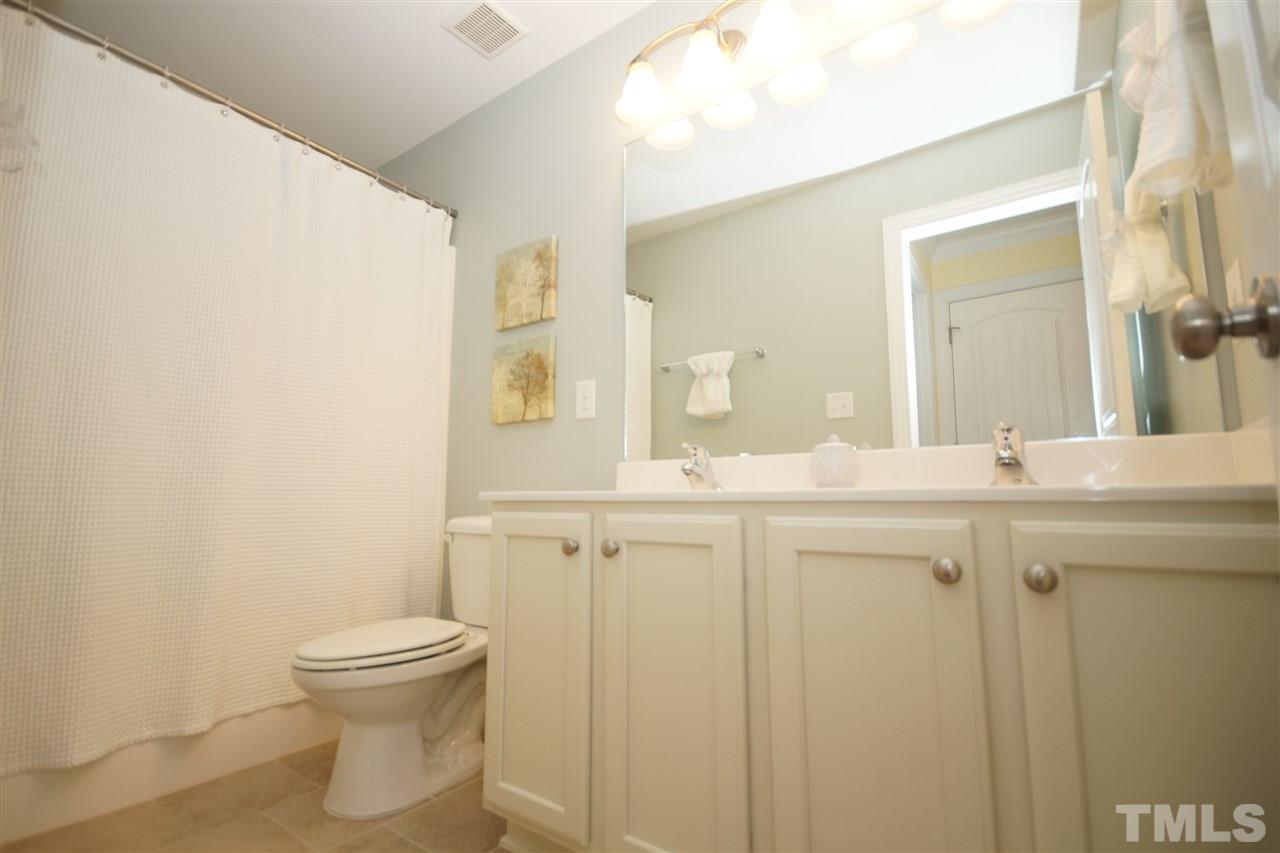 3015 Red Grape Drive Raleigh, NC 27607 - Photo 17 of 25 a bathroom with a sink a toilet and a mirror
