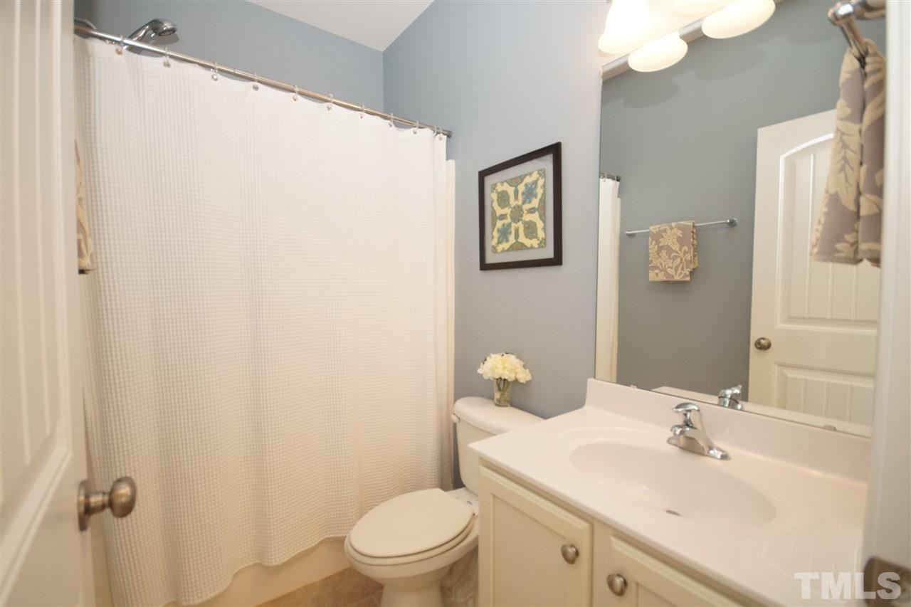 3015 Red Grape Drive Raleigh, NC 27607 - Photo 22 of 25 a bathroom with a sink mirror vanity and toilet