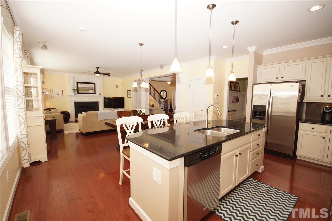 3015 Red Grape Drive Raleigh, NC 27607 - Photo 8 of 25 a kitchen with stainless steel appliances granite countertop a sink a stove and a refrigerator