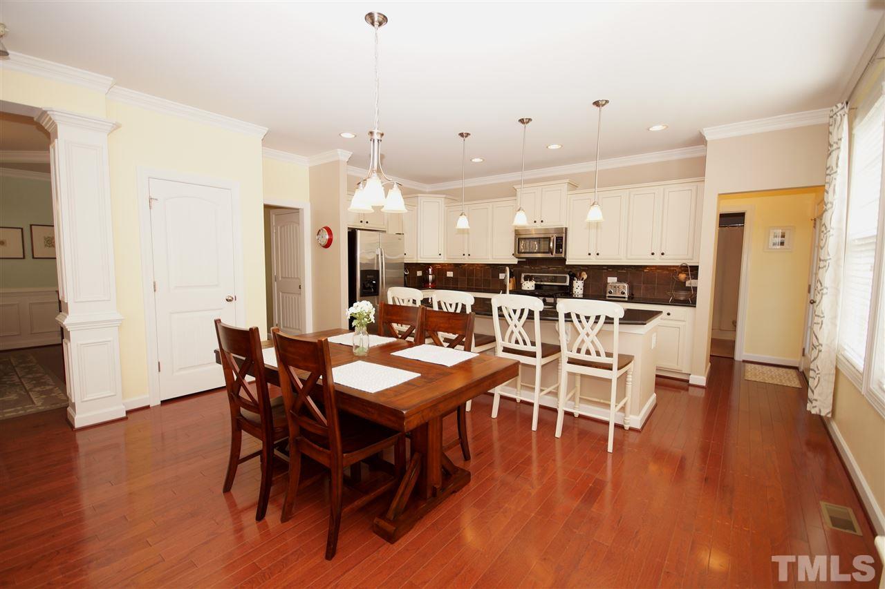 3015 Red Grape Drive Raleigh, NC 27607 - Photo 9 of 25 a view of a dining room with furniture and wooden floor