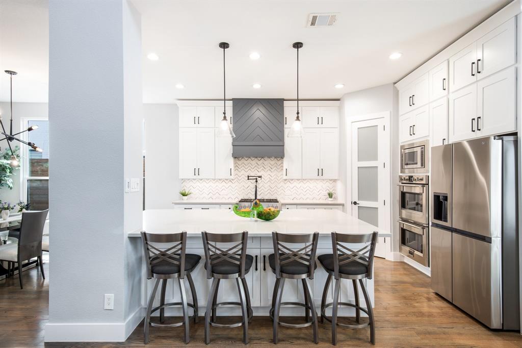 2093 Holt Way Grapevine, TX 76051 - Photo 7 of 40 a view of kitchen with stainless steel appliances kitchen island granite countertop dining table chairs and a refrigerator