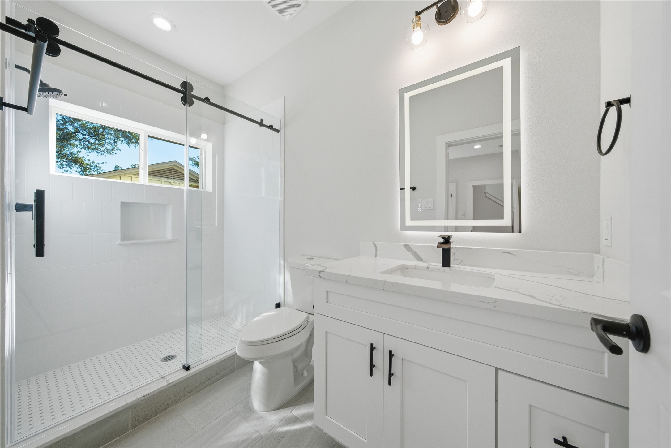 10929 Ivyridge Road, Unit B Houston, TX 77043 - Photo 15 of 37 a bathroom with a sink a toilet and shower