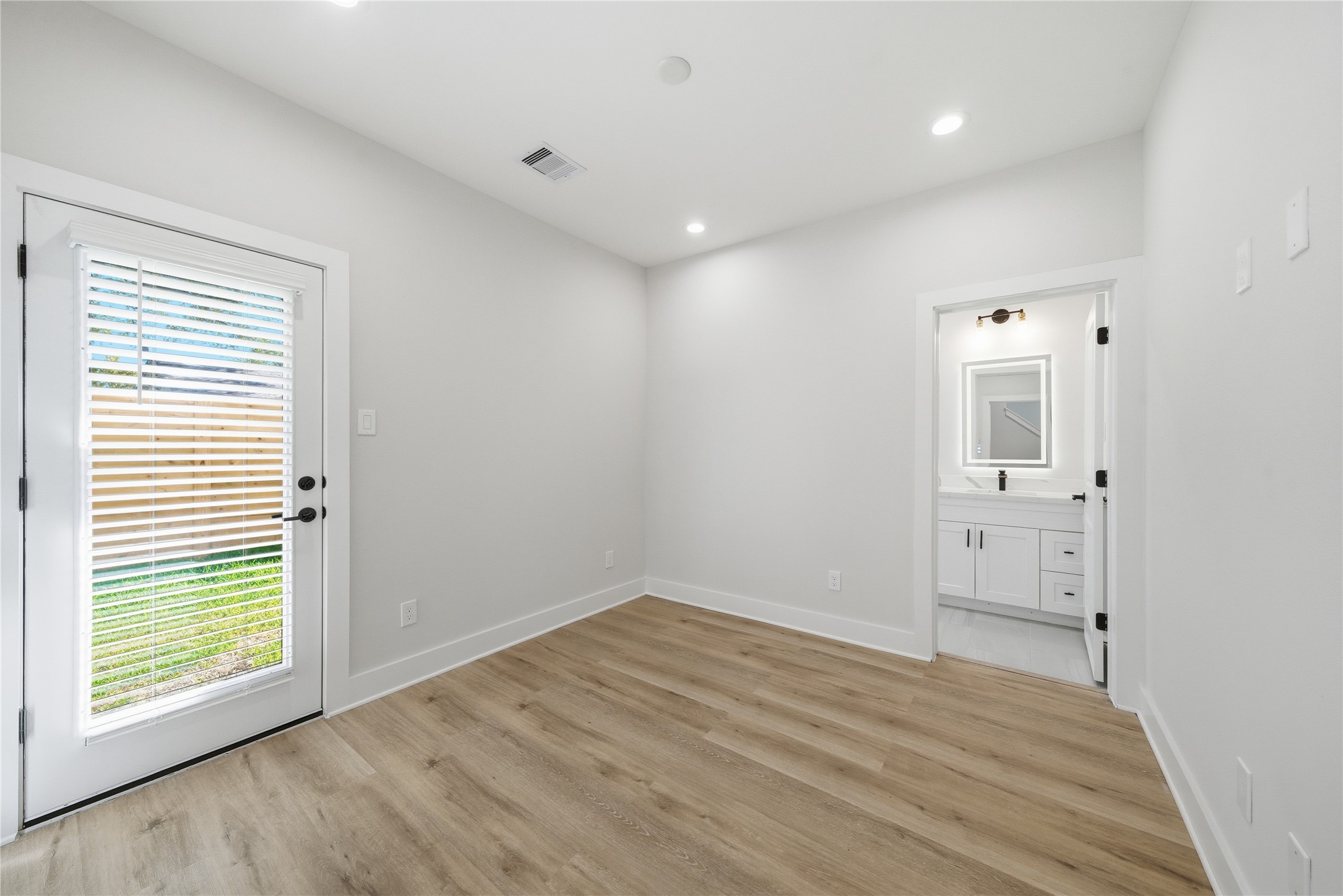 10929 Ivyridge Road, Unit B Houston, TX 77043 - Photo 17 of 37 wooden floor in an empty room with a window