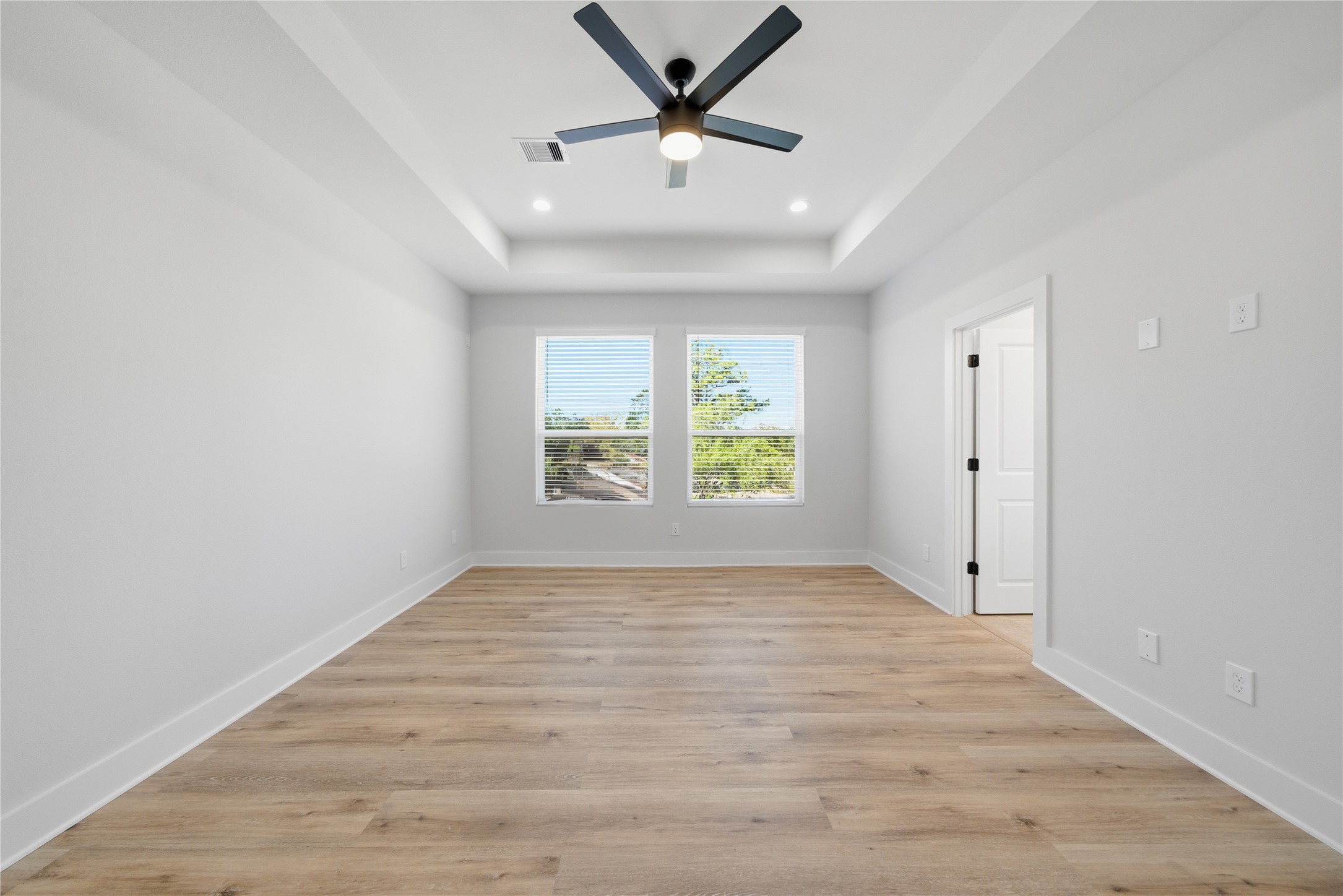 10929 Ivyridge Road, Unit B Houston, TX 77043 - Photo 19 of 37 wooden floor in an empty room with a window
