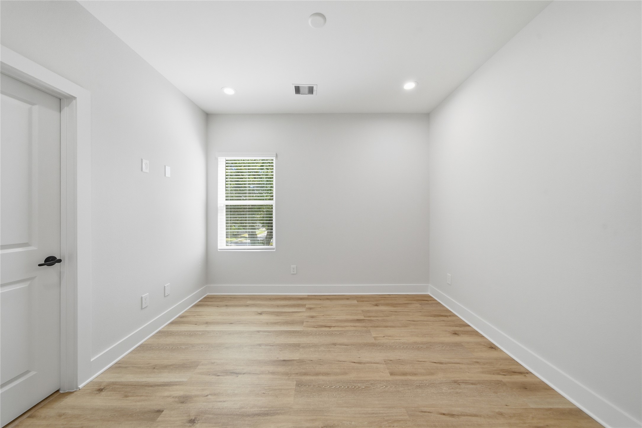 10929 Ivyridge Road, Unit B Houston, TX 77043 - Photo 21 of 37 a view of an empty room with wooden floor and a window
