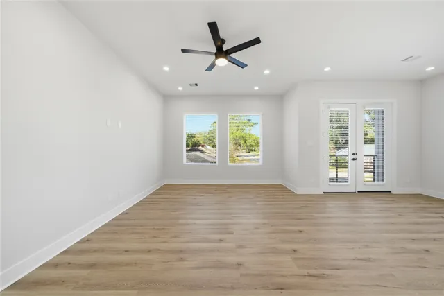 a kitchen with a sink cabinets stainless steel appliances and a window