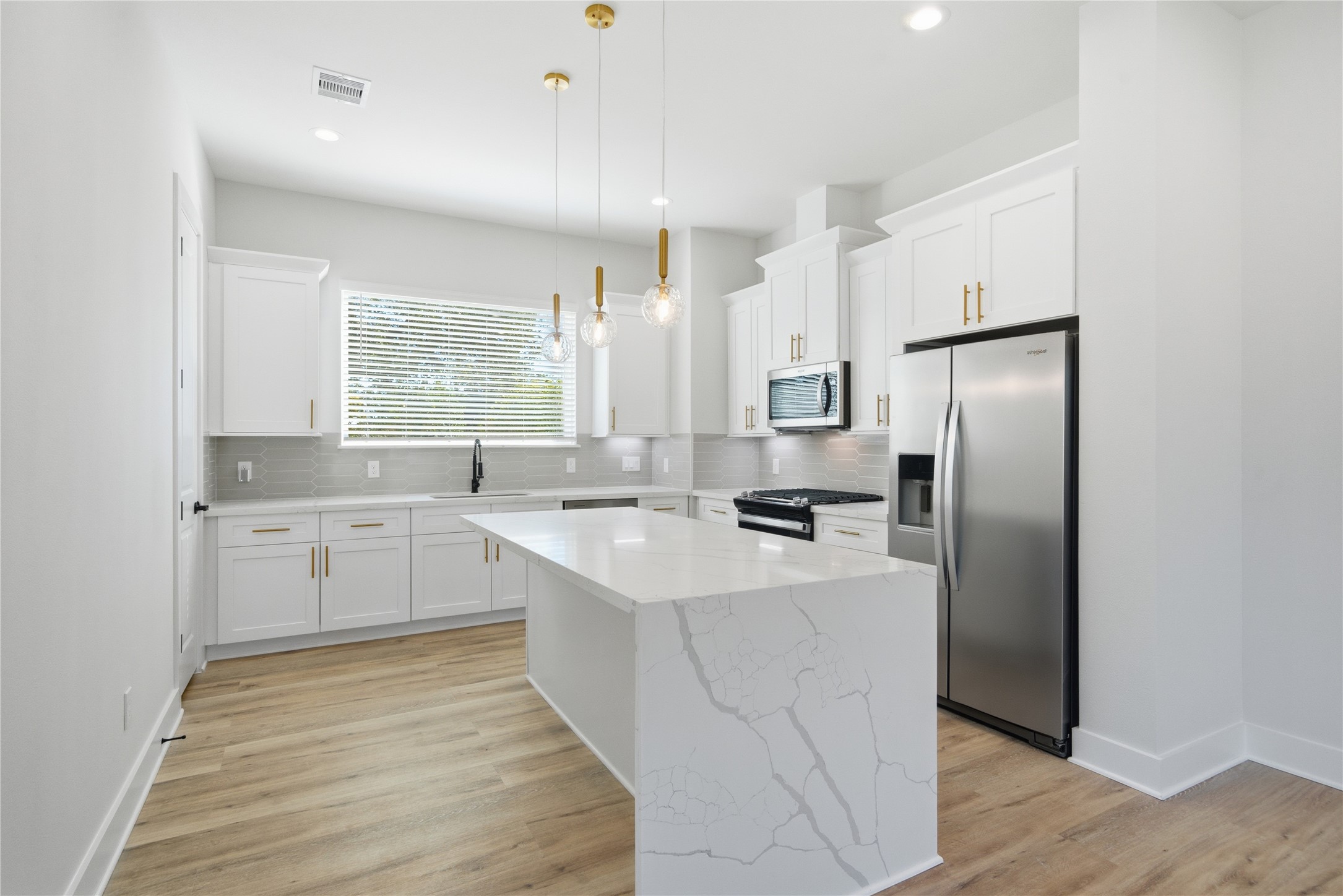 10929 Ivyridge Road, Unit B Houston, TX 77043 - Photo 29 of 37 a kitchen with white cabinets and white appliances