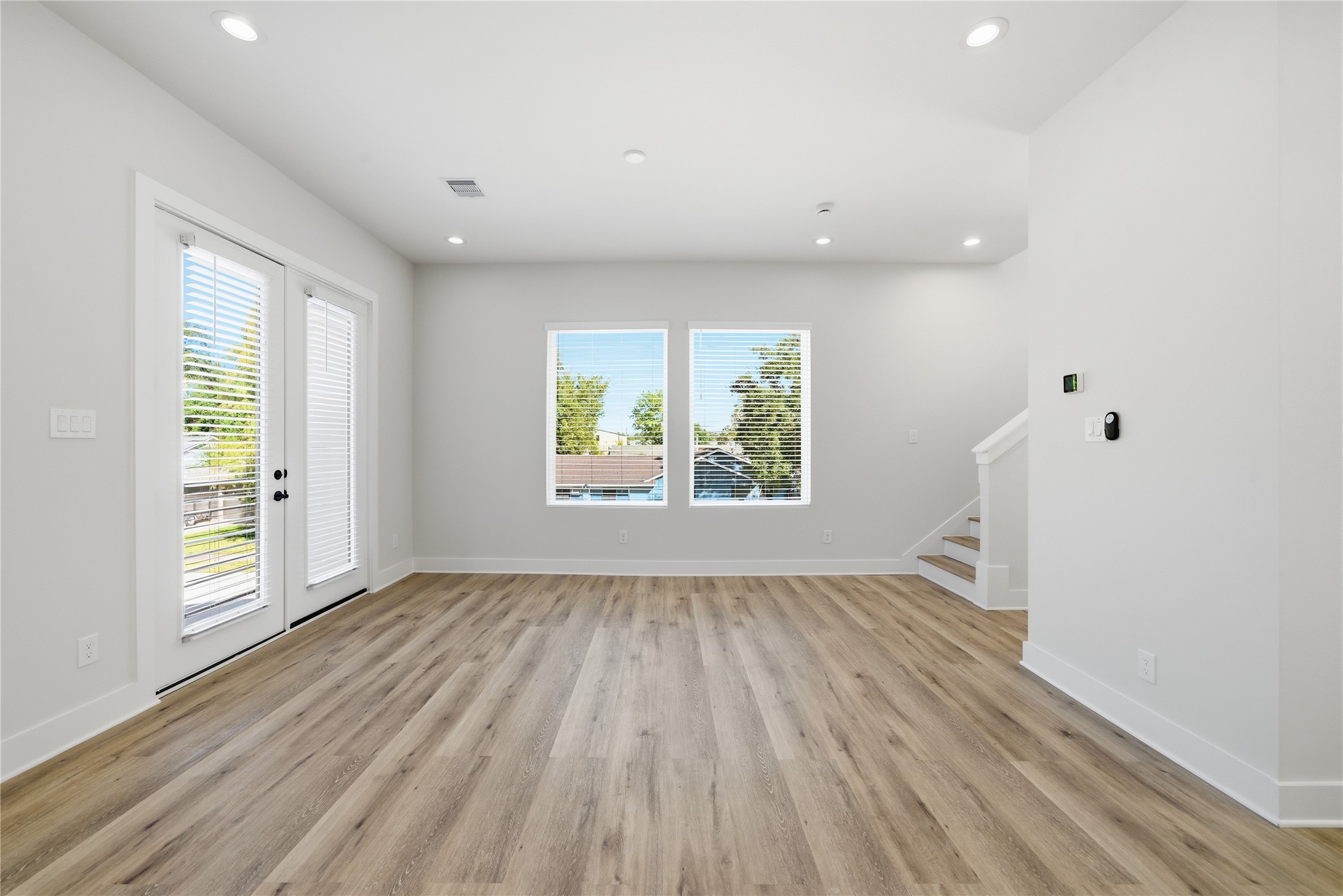 10929 Ivyridge Road, Unit B Houston, TX 77043 - Photo 35 of 37 an empty room with wooden floor and windows