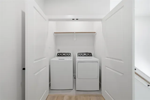 a spacious bathroom with a bathtub a double vanity sink and mirror