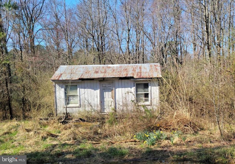 4424 Hooper Neck Road Taylors Island, MD 21669 - Photo 2 of 14 a backyard of a house with large trees