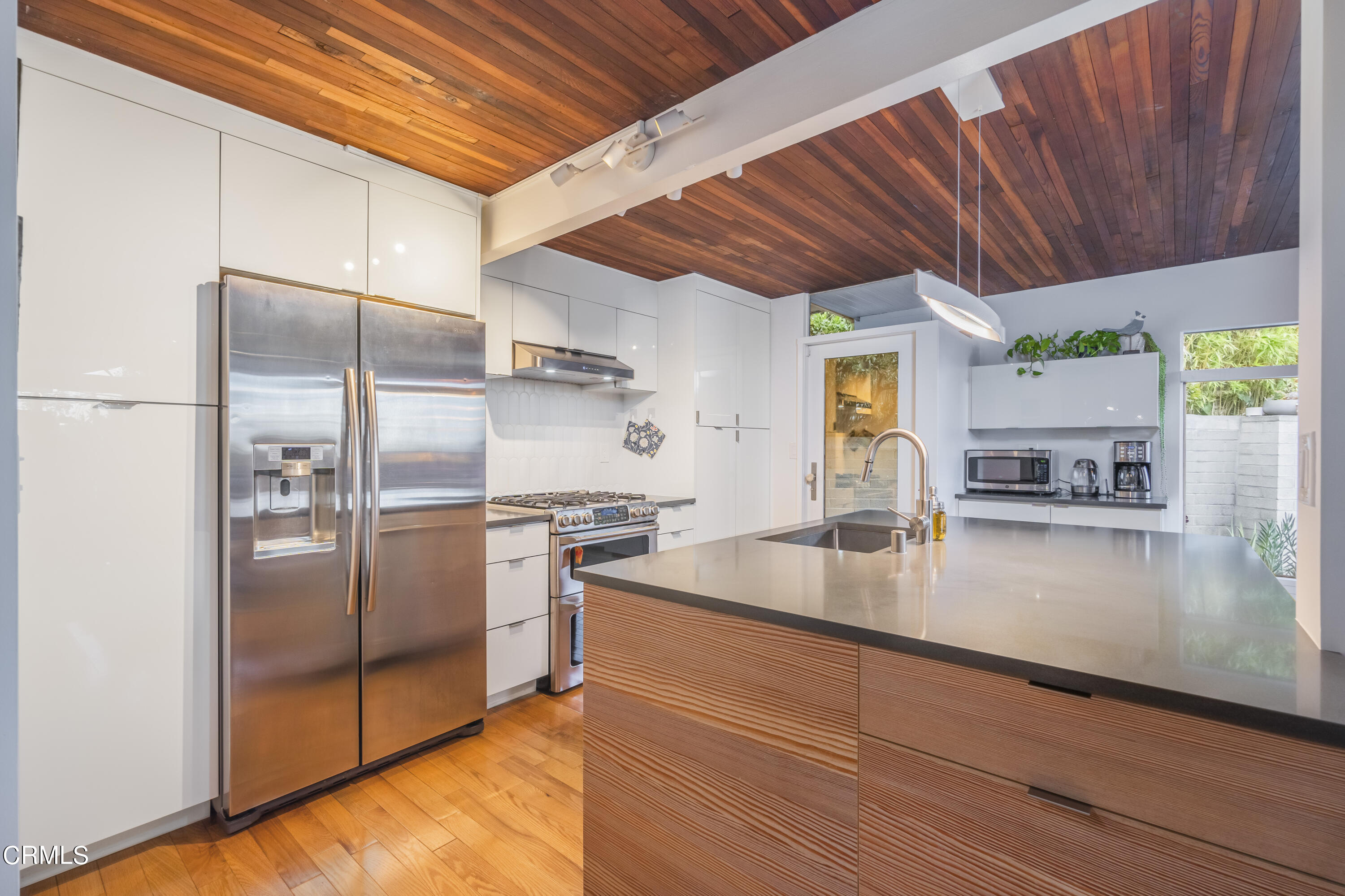 444 Sequoia Drive Pasadena, CA 91105 - Photo 9 of 38 a kitchen with stainless steel appliances granite countertop a refrigerator a stove and a sink with cabinets