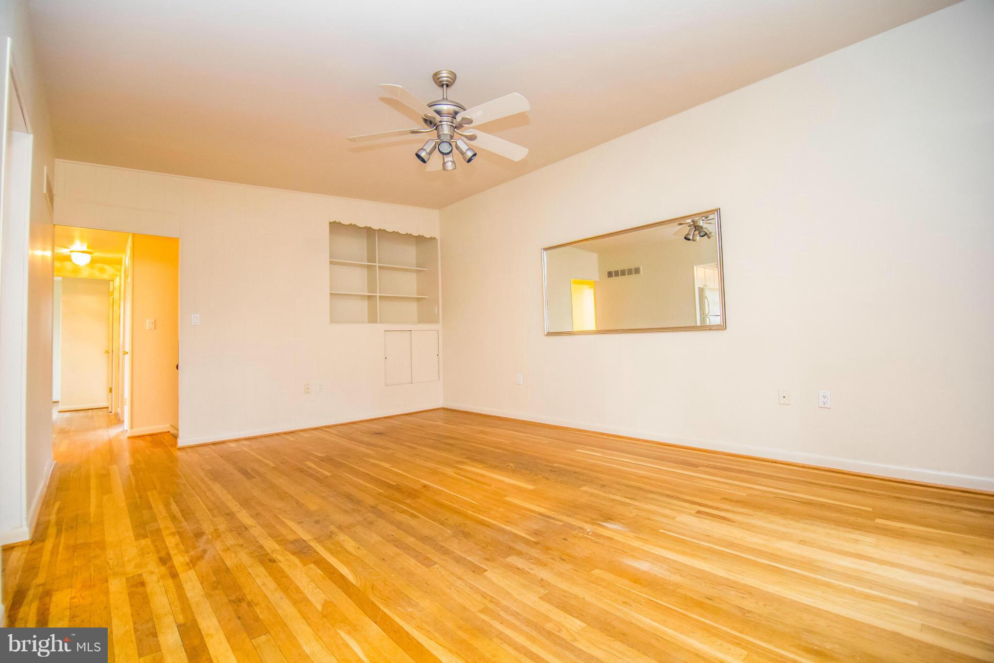6834 Queens Ferry Road Baltimore, MD 21239 - Photo 4 of 21 Living Room w/ built-in's and beautiful HW floors