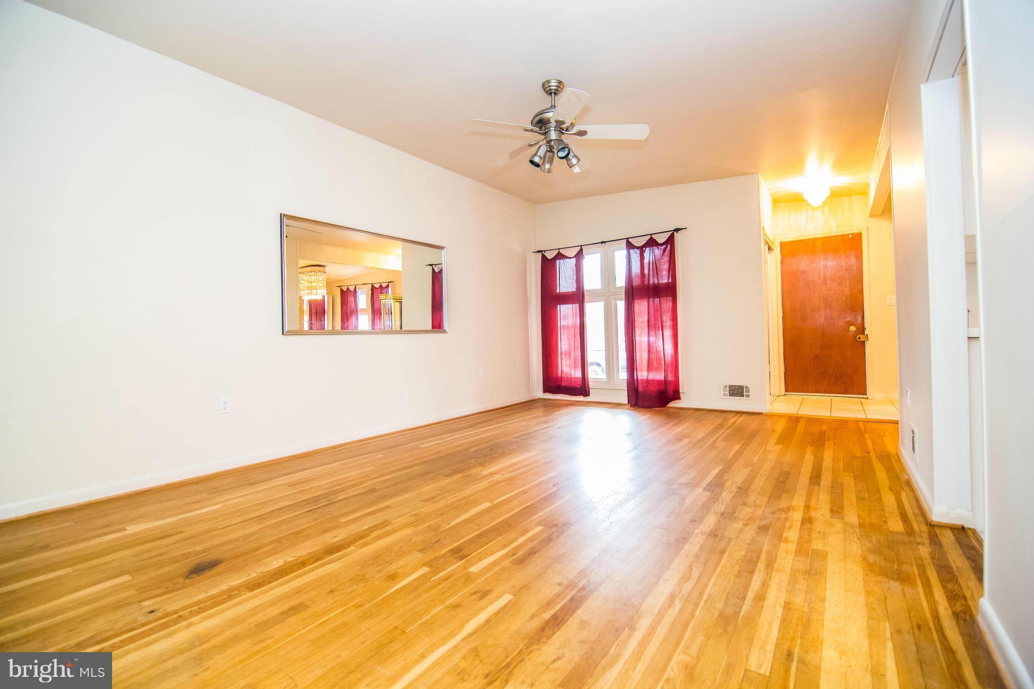 6834 Queens Ferry Road Baltimore, MD 21239 - Photo 5 of 21 Living Room w/ built-in's and beautiful HW floors