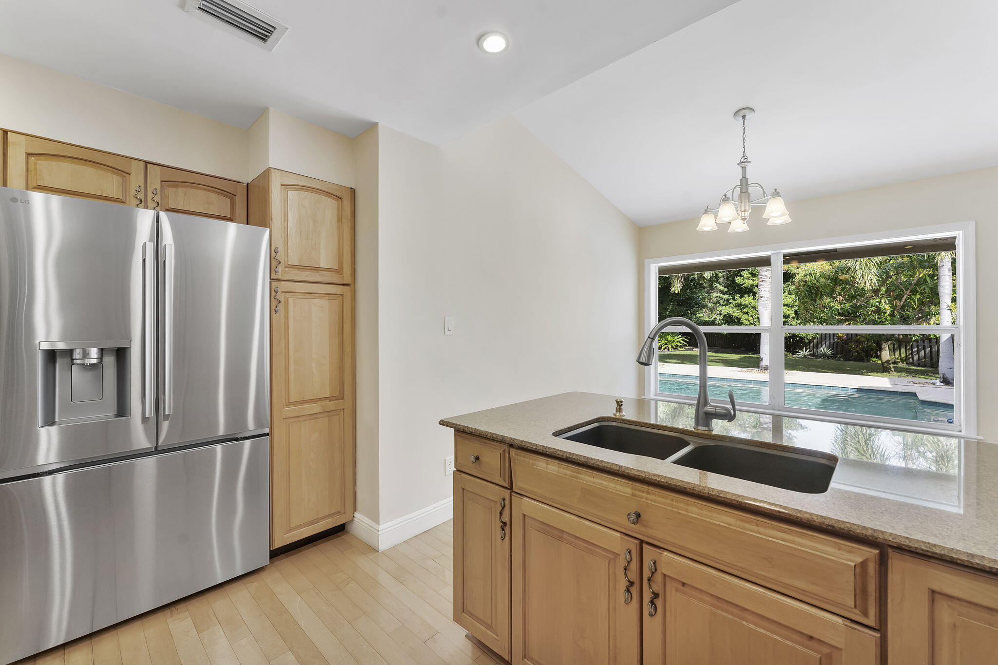 2415 Northwest 31st Street Boca Raton, FL 33431 - Photo 13 of 41 a kitchen with stainless steel appliances granite countertop a refrigerator a sink and a stove