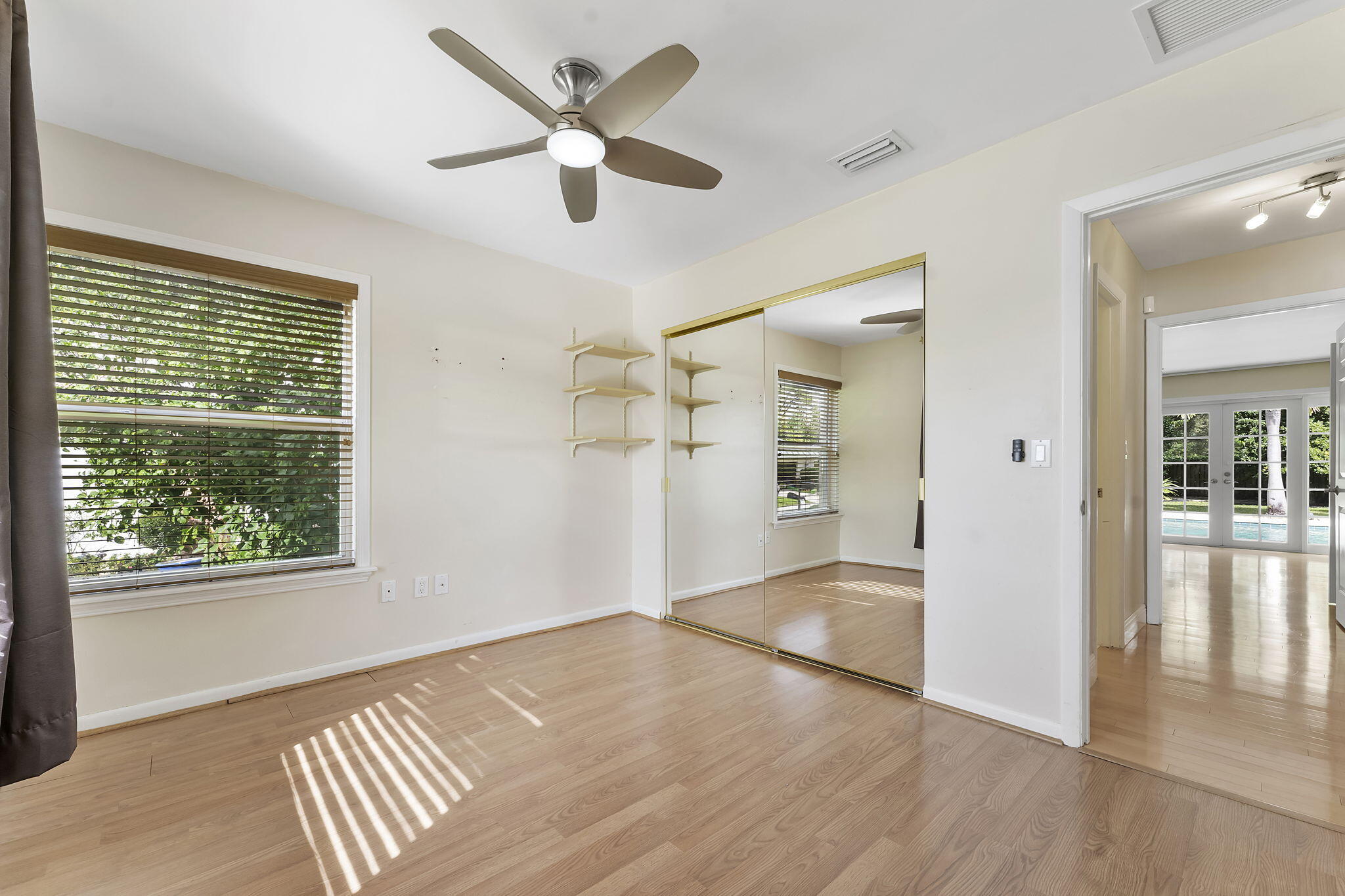 2415 Northwest 31st Street Boca Raton, FL 33431 - Photo 23 of 41 a view of an empty room with wooden floor and a window